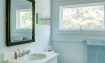 Master bath with salvaged Carrara marble countertop and heirloom mirror