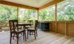 Walk out of the kitchen onto the private back porch for dining or lounging in the trees
